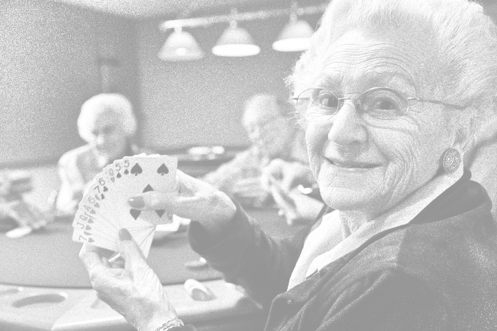 An old person holding a deck of cards